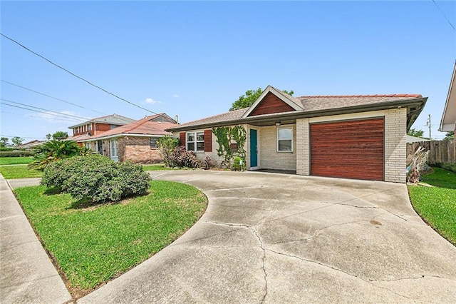 ranch-style home featuring a front yard and a garage