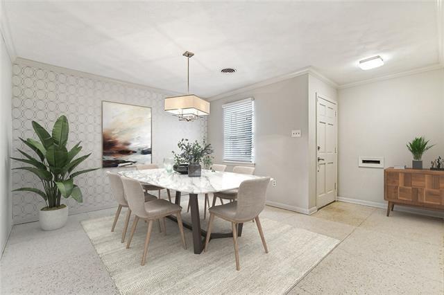 dining space with ornamental molding