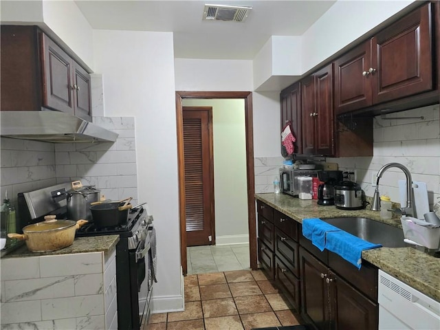 kitchen with light stone countertops, backsplash, electric range, dishwasher, and light tile patterned flooring