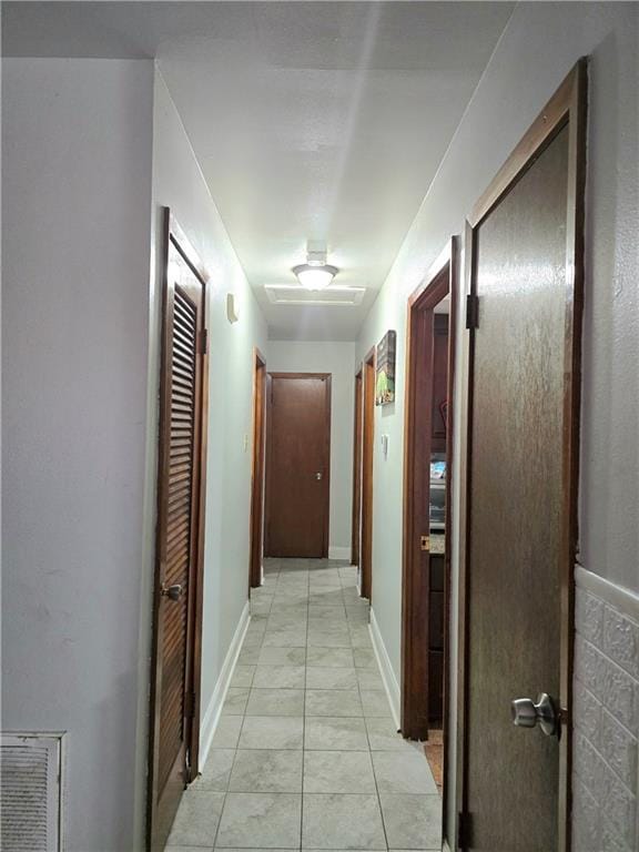 corridor featuring light tile patterned flooring