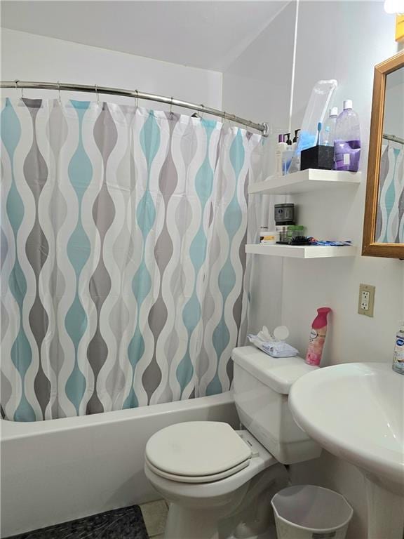 full bathroom featuring tile patterned floors, shower / bath combination with curtain, toilet, and sink