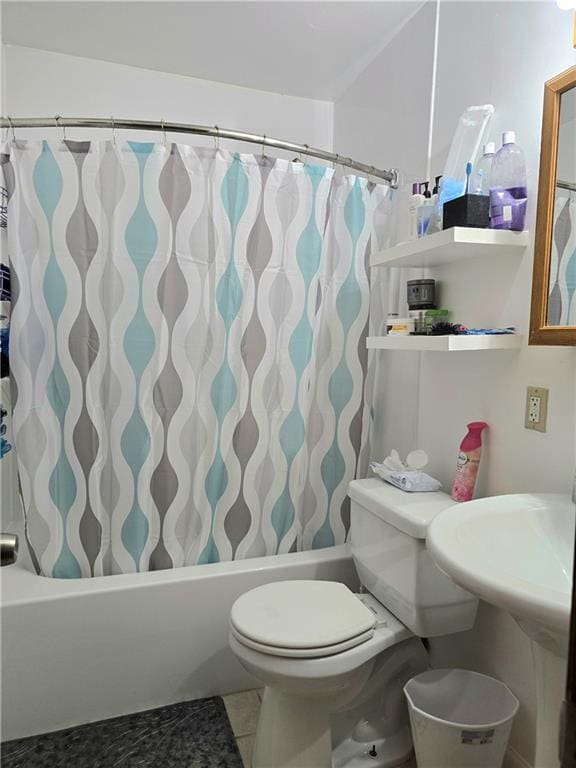 bathroom with tile patterned floors, shower / bath combo with shower curtain, and toilet