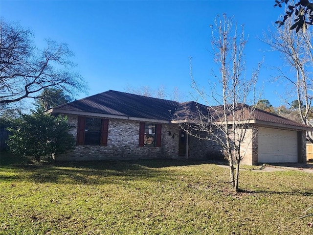 single story home featuring a garage and a front lawn