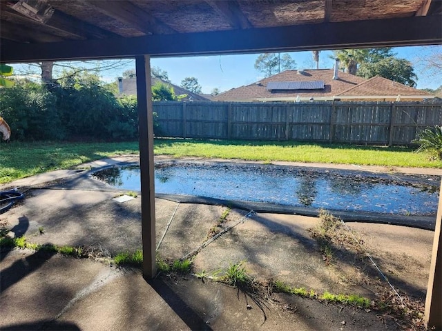 view of pool with a lawn