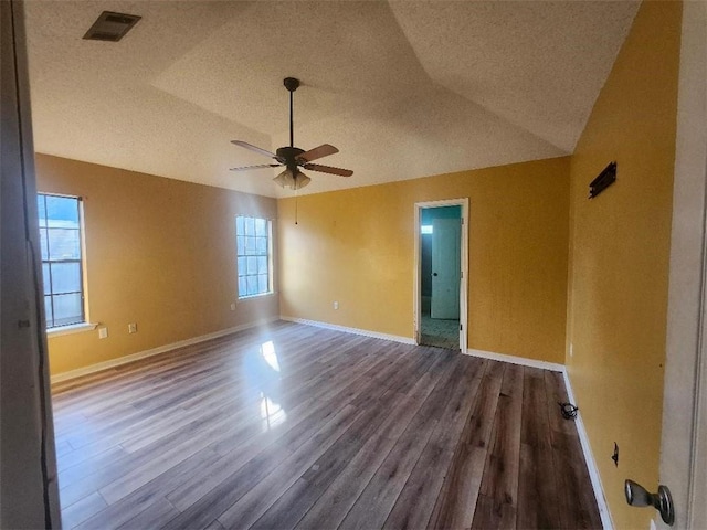 empty room with wood-type flooring, ceiling fan, and lofted ceiling