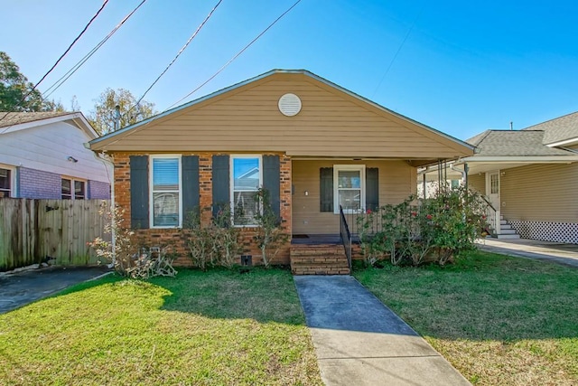 bungalow-style house featuring a porch, a front yard, fence, and brick siding