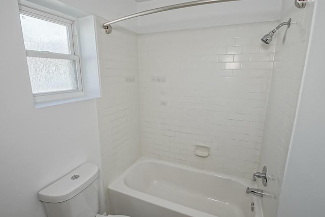 bathroom with bathtub / shower combination and toilet