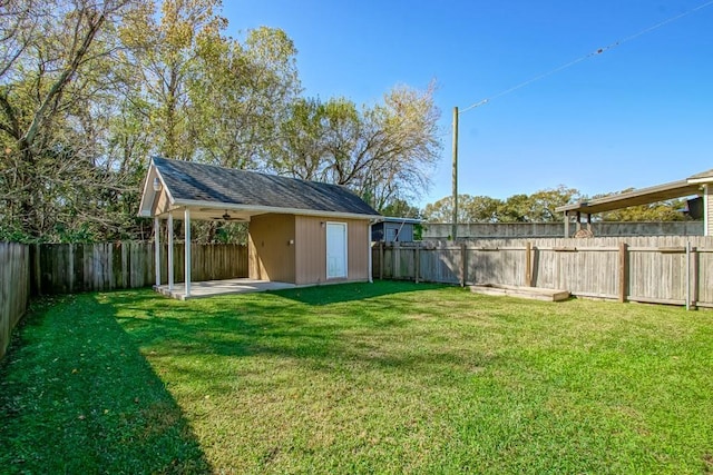 view of yard with a fenced backyard, an outdoor structure, and a shed