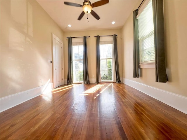 unfurnished room featuring ceiling fan and hardwood / wood-style floors