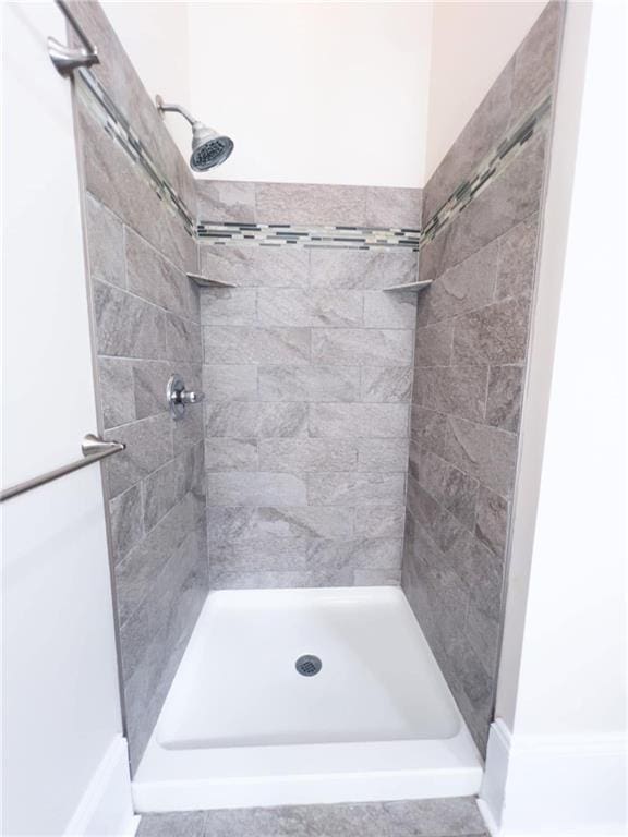 bathroom with tiled shower