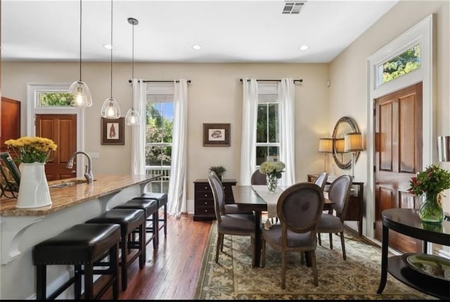 dining room with dark hardwood / wood-style floors and sink