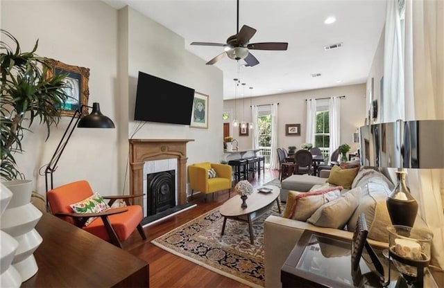 living room with hardwood / wood-style flooring and ceiling fan