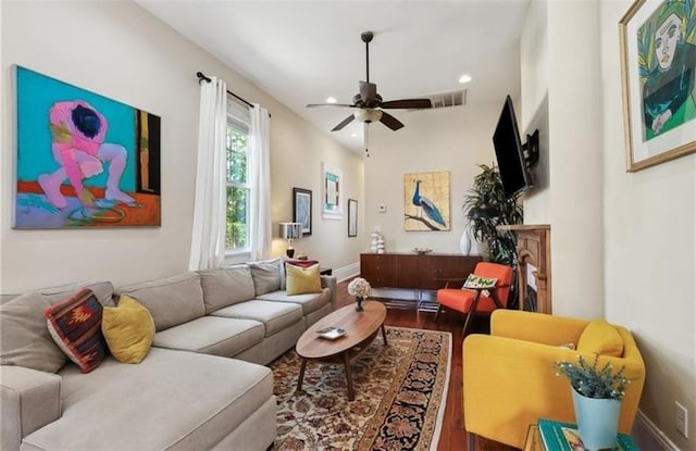 living room featuring ceiling fan and wood-type flooring