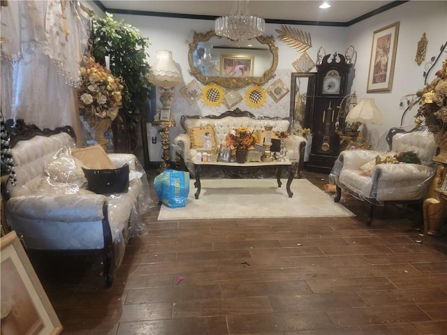 living area with crown molding and a chandelier