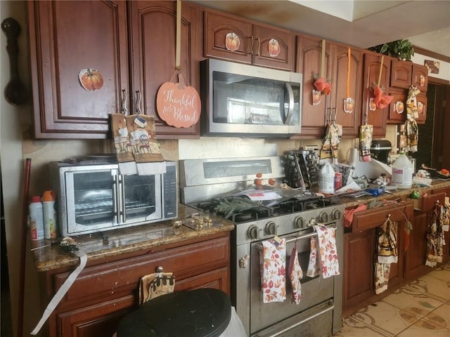 kitchen with light tile patterned floors and appliances with stainless steel finishes