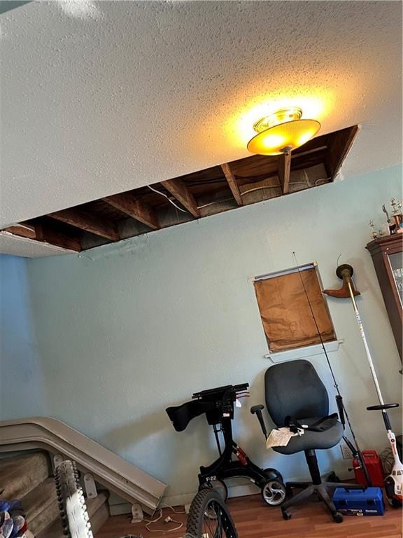 interior space featuring a textured ceiling and hardwood / wood-style flooring