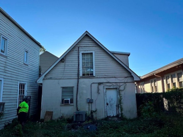 rear view of house featuring central air condition unit