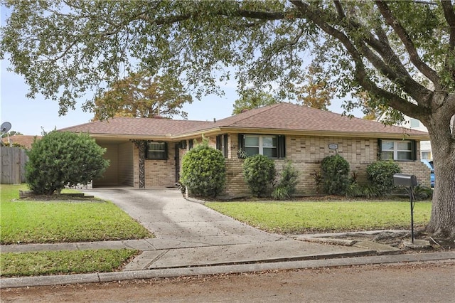 ranch-style home featuring a carport and a front lawn