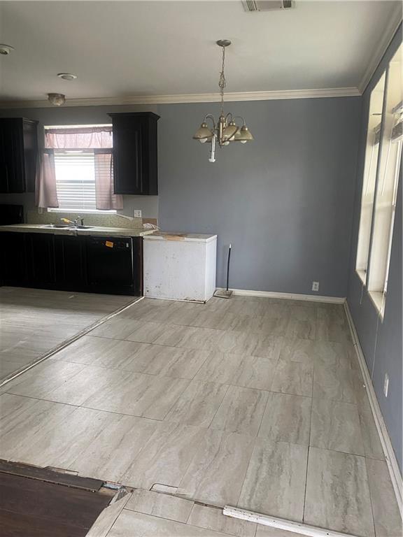 kitchen featuring sink, crown molding, an inviting chandelier, hanging light fixtures, and black dishwasher