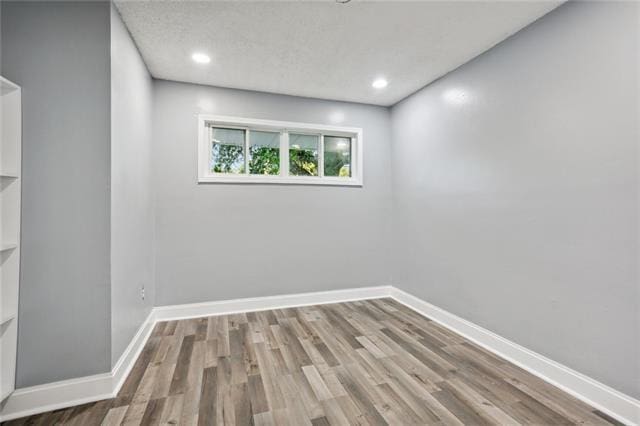 spare room with hardwood / wood-style floors