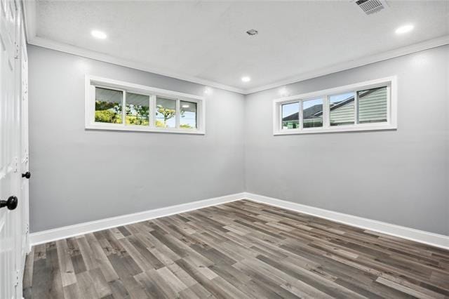 unfurnished room with dark hardwood / wood-style flooring and ornamental molding