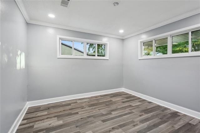 unfurnished room with dark wood-type flooring and ornamental molding