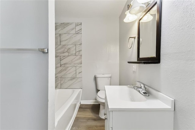 full bathroom with hardwood / wood-style flooring, vanity, toilet, and tub / shower combination