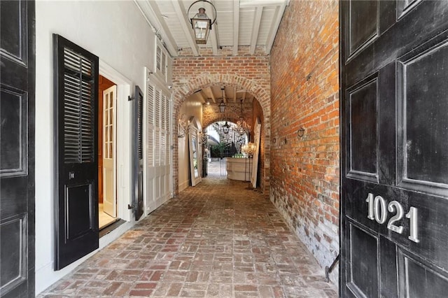 hallway with brick wall