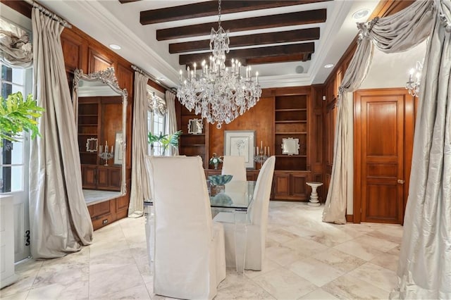 dining room with built in features, beam ceiling, an inviting chandelier, and crown molding