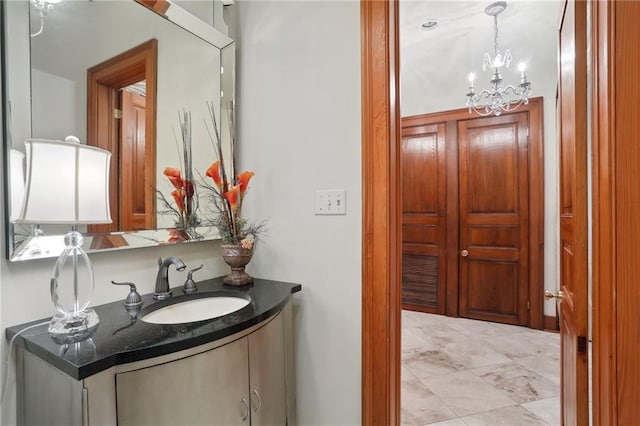 bathroom with vanity and a notable chandelier