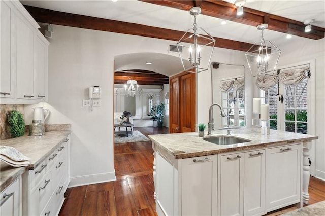 kitchen featuring white cabinetry and hanging light fixtures