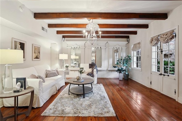 living room featuring beam ceiling, dark hardwood / wood-style floors, and a notable chandelier