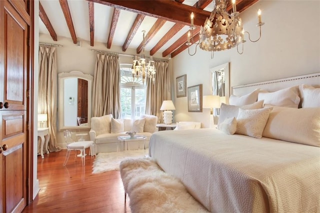 bedroom featuring hardwood / wood-style floors, lofted ceiling with beams, and a notable chandelier