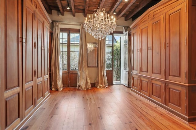 miscellaneous room with beamed ceiling, wood ceiling, light hardwood / wood-style flooring, and a chandelier