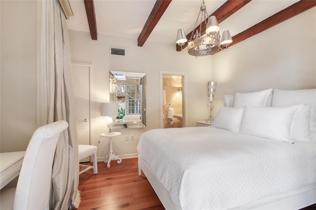 bedroom featuring beamed ceiling, wood-type flooring, and a chandelier