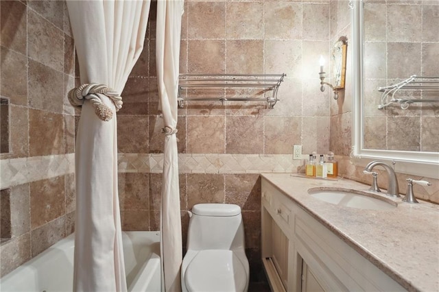 full bathroom featuring shower / tub combo, vanity, toilet, and tile walls