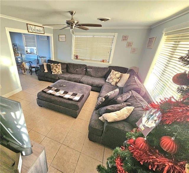 living room featuring crown molding, ceiling fan, and light tile patterned floors