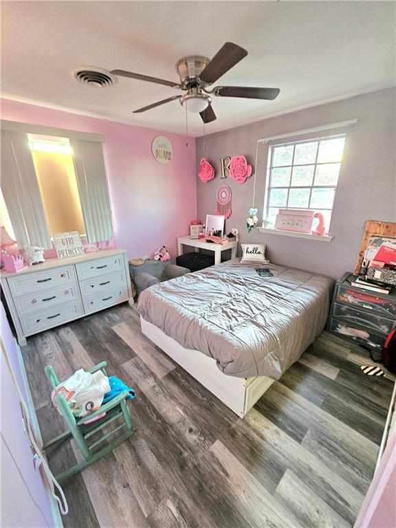 bedroom featuring dark hardwood / wood-style flooring and ceiling fan