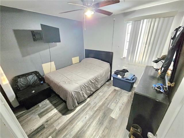 bedroom with light hardwood / wood-style flooring and ceiling fan