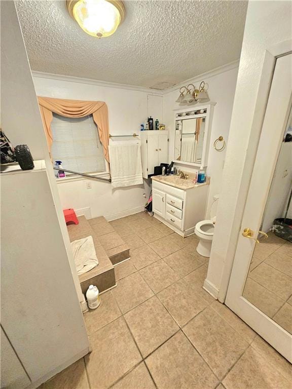 bathroom featuring ornamental molding, vanity, a textured ceiling, and toilet