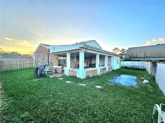 property exterior at dusk with a yard