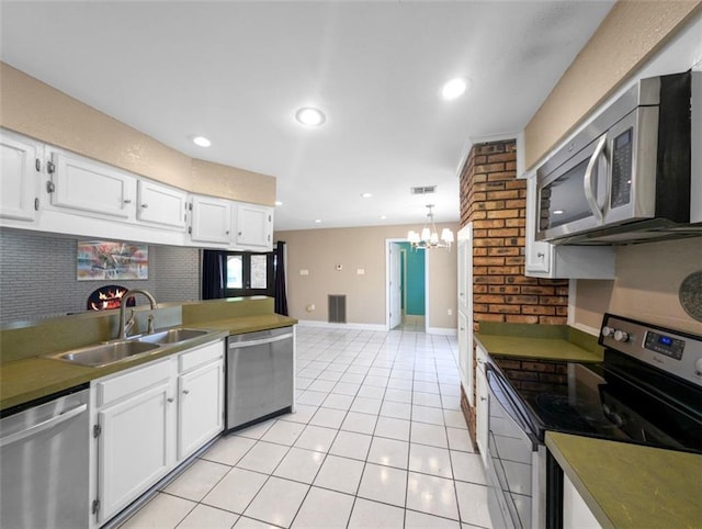 kitchen with white cabinetry, sink, a notable chandelier, and appliances with stainless steel finishes