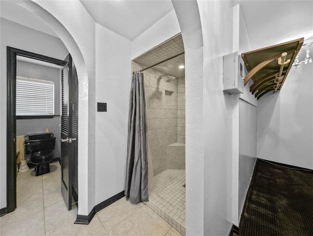 bathroom featuring tile patterned floors, toilet, and a shower with shower curtain