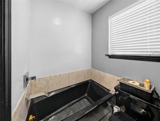 bathroom with tiled tub