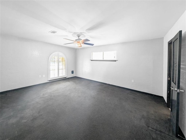 carpeted empty room featuring ceiling fan