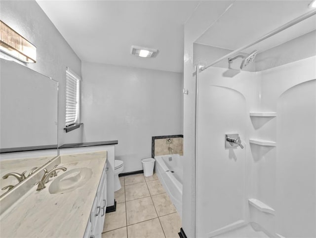 bathroom with tile patterned flooring, vanity, toilet, and a tub