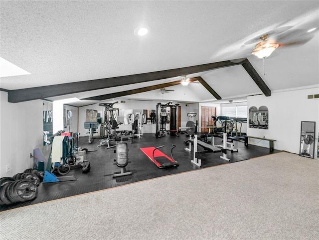 workout area featuring ceiling fan, a textured ceiling, and vaulted ceiling