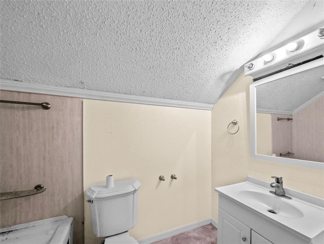 bathroom featuring a textured ceiling, vanity, toilet, and vaulted ceiling