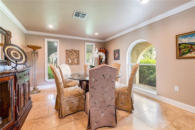 dining space with crown molding and light tile patterned flooring