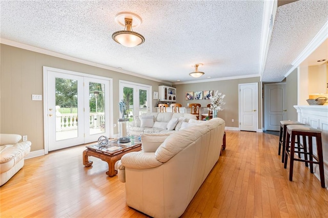 living room featuring crown molding, a textured ceiling, light hardwood / wood-style floors, and french doors